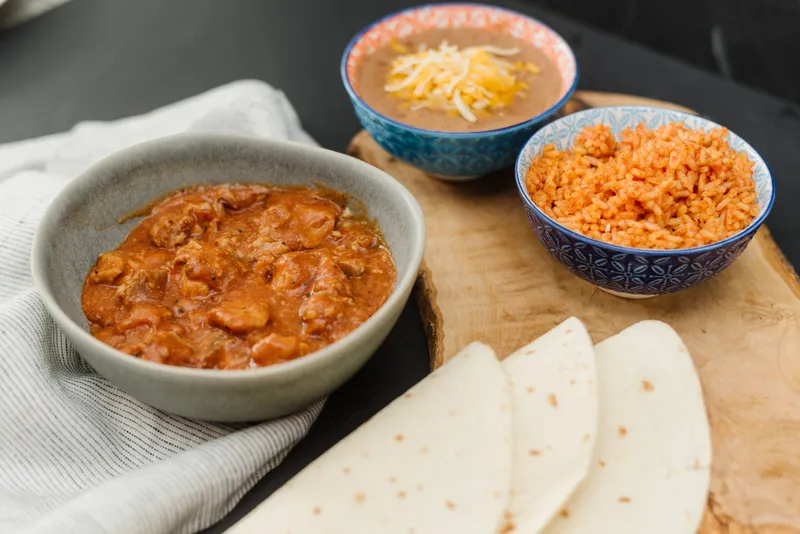 Homemade chile verde dinner served with flour tortillas at Su Casa Midvale