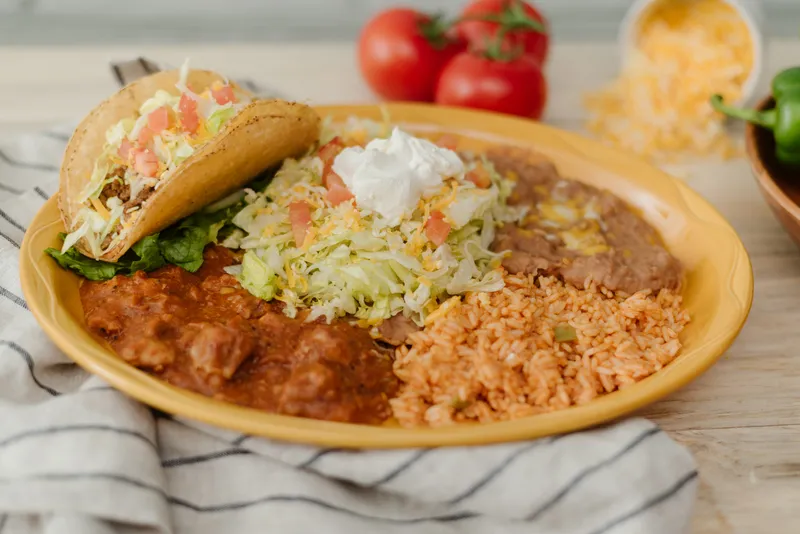 Authentic Mexican dinner plate with rice, beans, and enchiladas at Su Casa Restaurant in Midvale, UT